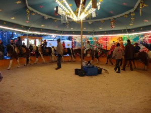 Children riding ponies in the Wasserturm Christmas market